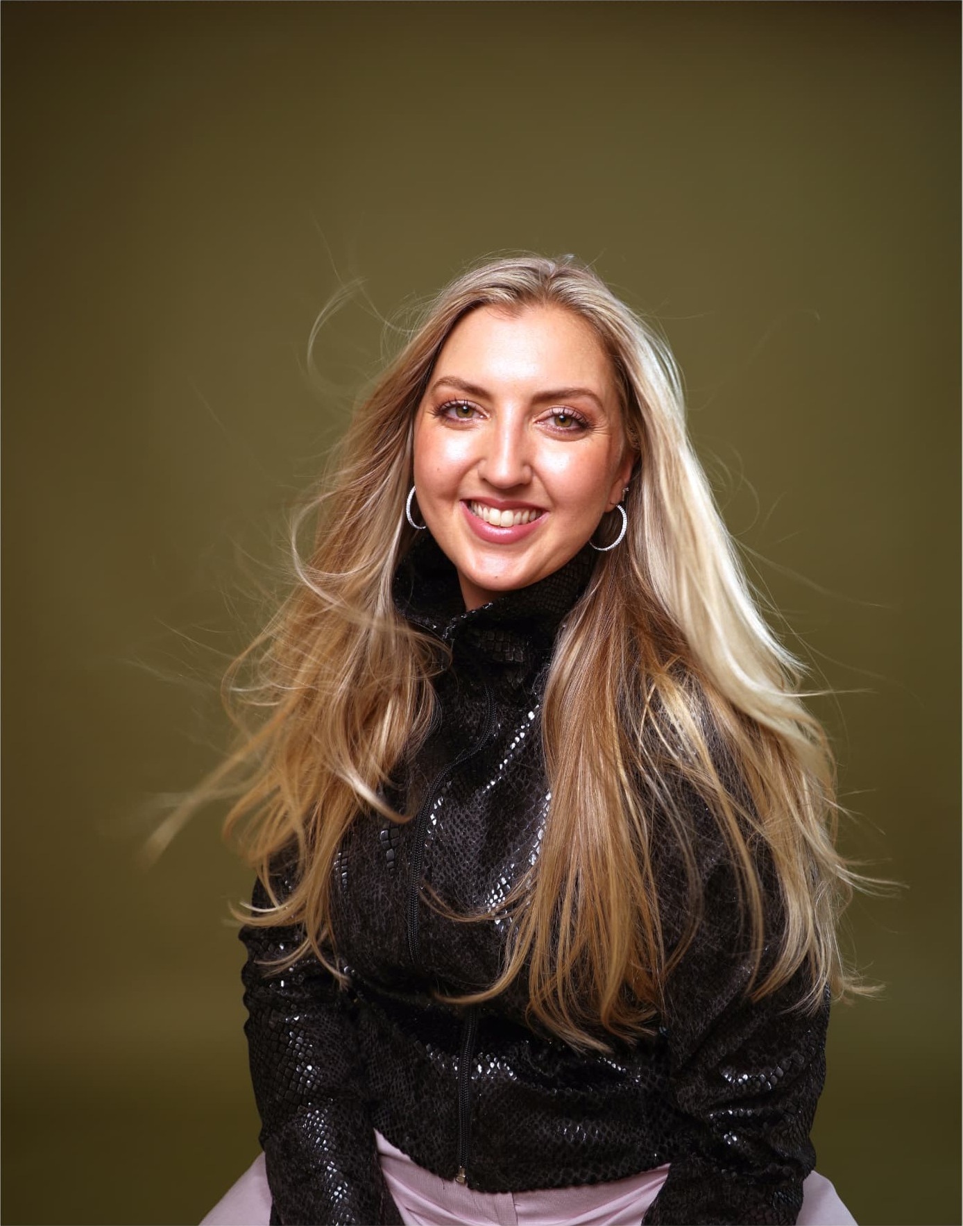Charl Oaten smiling, hair caught mid-movement
