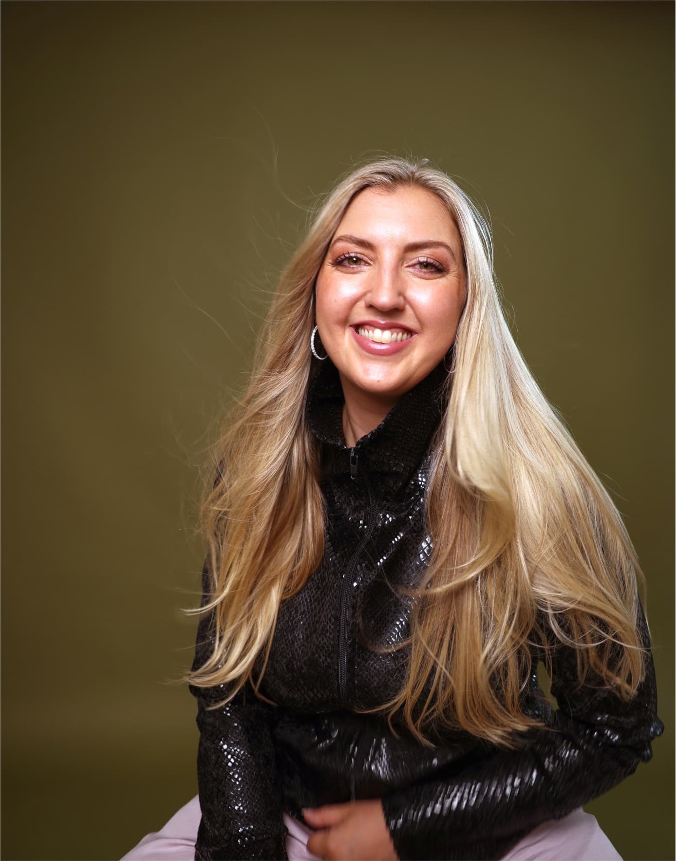 Charl Oaten laughing in a black sequinned jacket